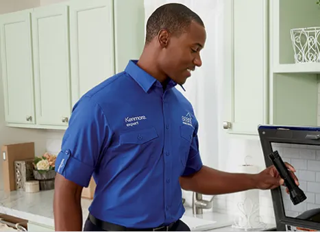 Sears Home Services Laundry Technician Maintaining the Washer
